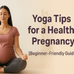 “A pregnant woman practicing yoga in a bright, peaceful room, sitting cross-legged on a mat with eyes closed and hands resting on her knees, wearing a pink top and gray leggings, symbolizing calmness and wellness during pregnancy.”