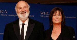 Rob Reiner and his wife Michele Singer Reiner smiling together at a formal event with a blue background